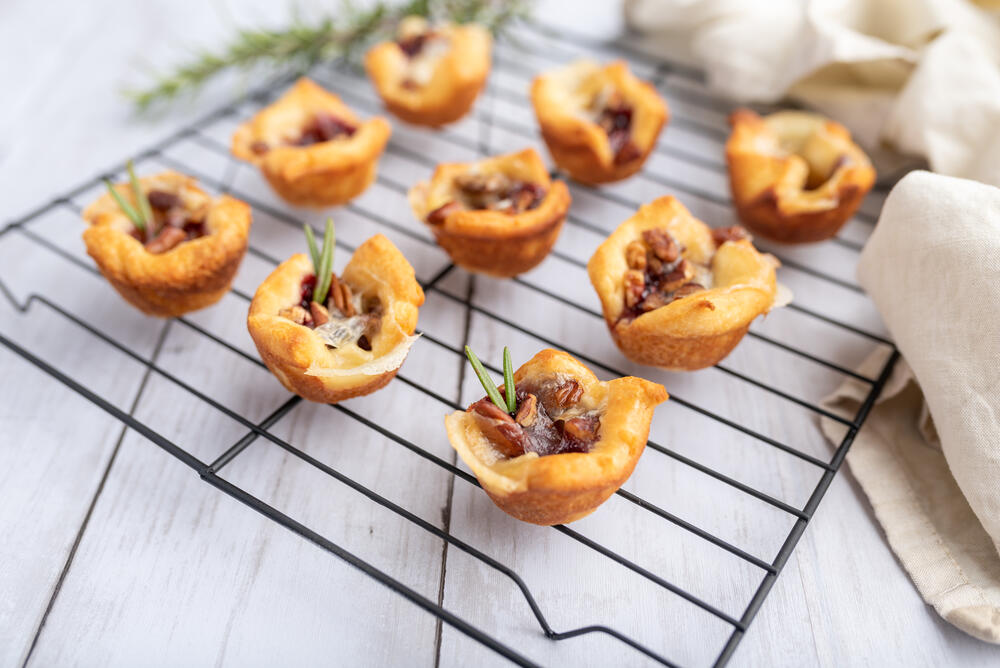 Brie bites with jam and nuts in crescent dough, mini appetizer dessert with cranberry or any jelly